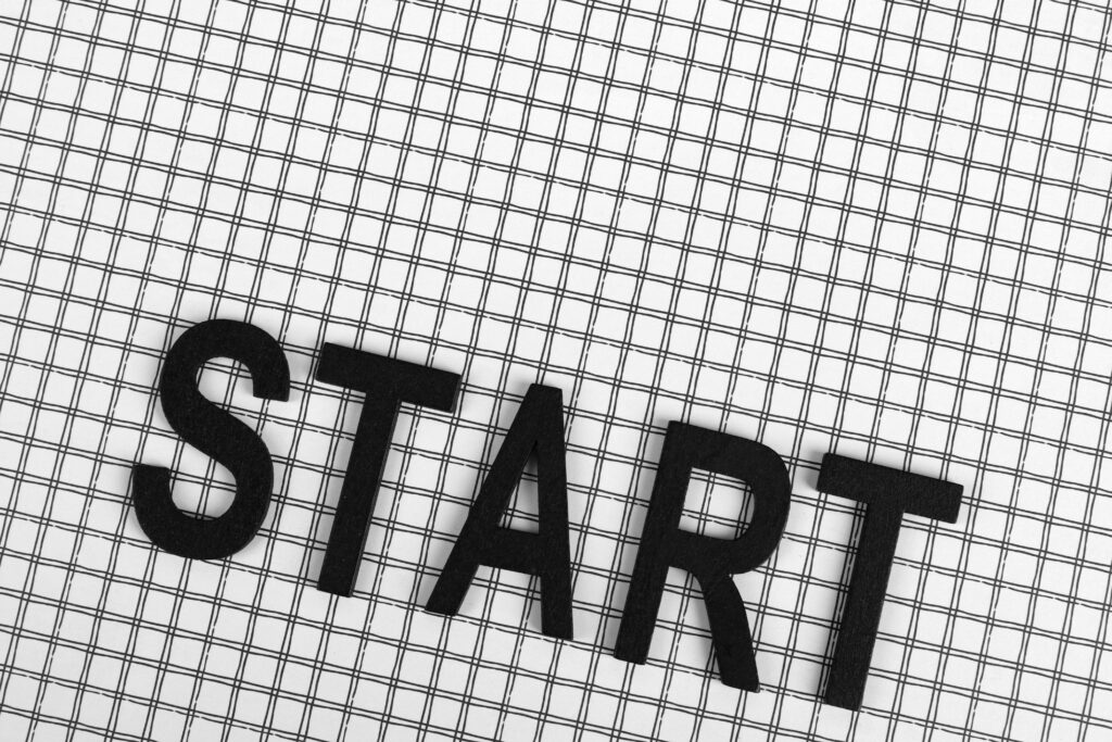 pexels-photo-6480812-6480812 Black letters spelling 'START' on a white grid background, conceptual and minimalistic design.